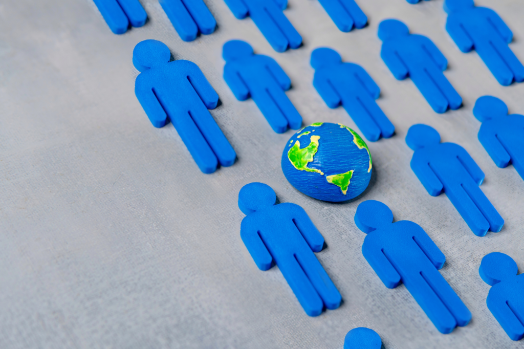 World globe surrounded by blue human figures